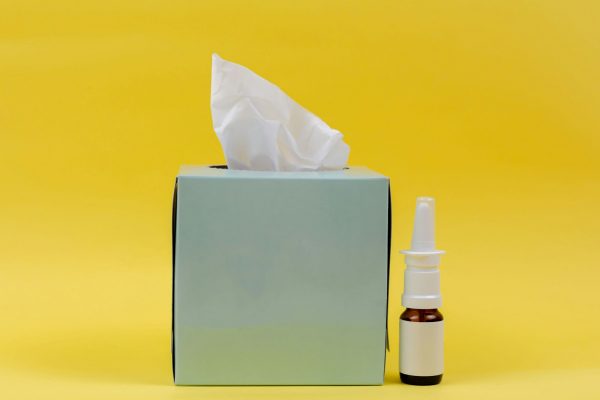 white and brown bottle beside white tissue box